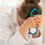 Stressed medical doctor woman in office